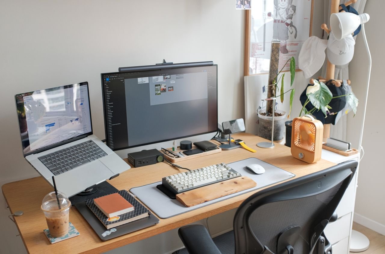 Services A sleek office setup featuring a laptop, monitor, and stylish accessories enhancing productivity.